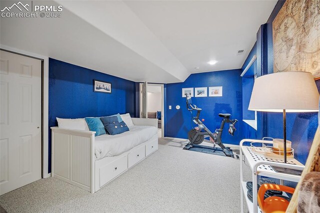 carpeted bedroom with baseboards, vaulted ceiling, and visible vents