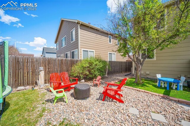 exterior space featuring fence and an outdoor fire pit
