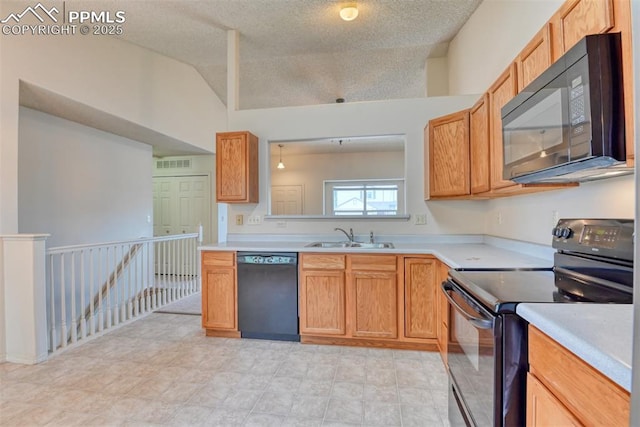 kitchen featuring light countertops, a sink, and black appliances