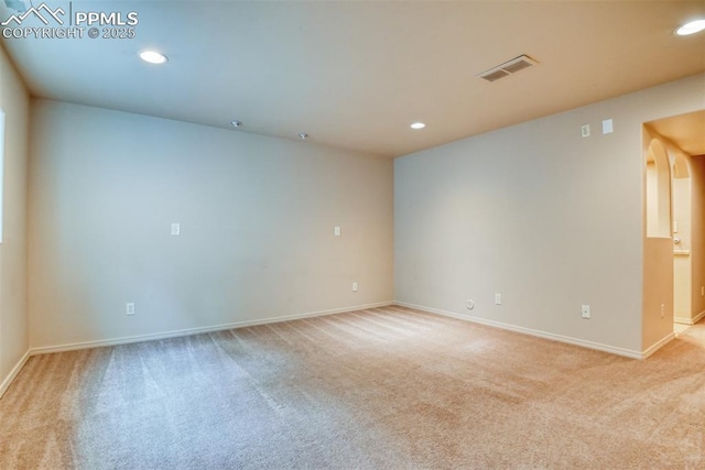 empty room featuring recessed lighting, baseboards, visible vents, and light carpet