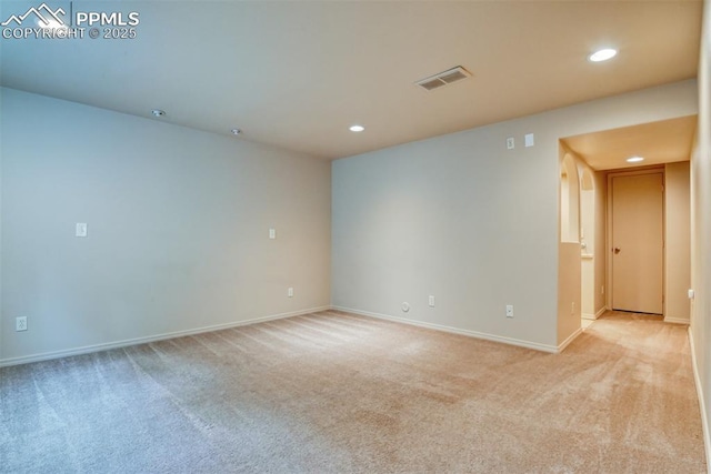 unfurnished room featuring visible vents, recessed lighting, baseboards, and light colored carpet