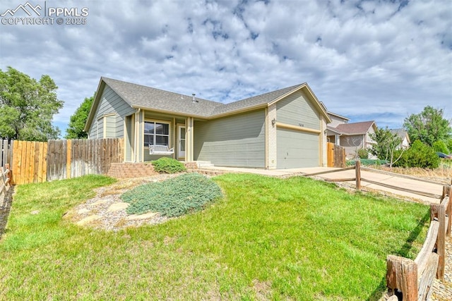 ranch-style house featuring an attached garage, a front lawn, fence, and driveway