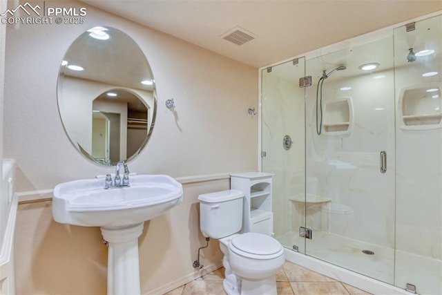 bathroom with visible vents, baseboards, tile patterned floors, toilet, and a marble finish shower