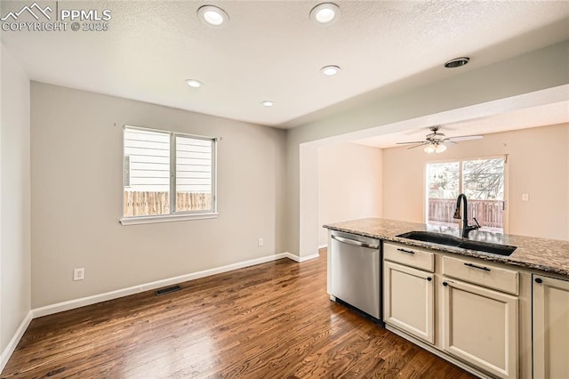 4337 Levi Ln, Colorado Springs, CO 80925 - kitchen featuring stainless steel dishwasher, a sink, baseboards, and dark wood-style floors