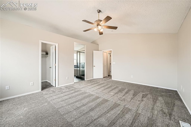 4337 Levi Ln, Colorado Springs, CO 80925 - unfurnished bedroom featuring carpet flooring, vaulted ceiling, a walk in closet, and visible vents