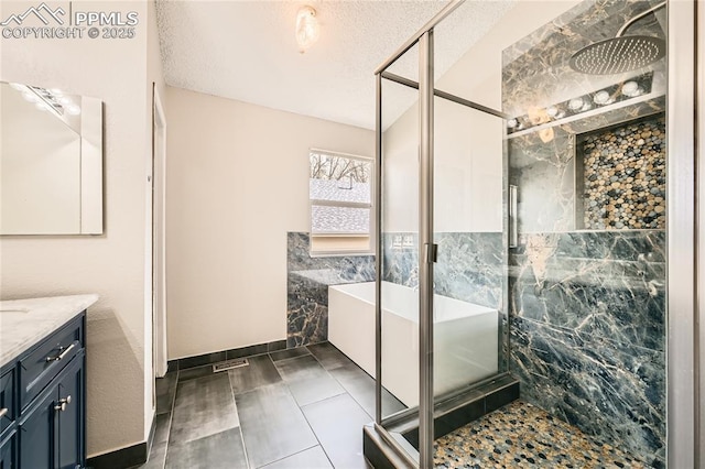 4337 Levi Ln, Colorado Springs, CO 80925 - bathroom with a tub, vanity, a stall shower, and a textured ceiling