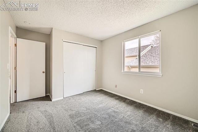 4337 Levi Ln, Colorado Springs, CO 80925 - unfurnished bedroom featuring carpet floors, a textured ceiling, baseboards, and a closet