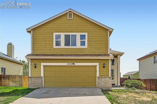 4337 Levi Ln, Colorado Springs, CO 80925 - traditional-style home featuring an attached garage, fence, brick siding, and concrete driveway