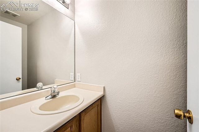 4337 Levi Ln, Colorado Springs, CO 80925 - bathroom with a textured wall, visible vents, and vanity