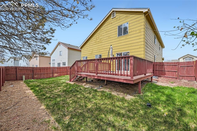 4337 Levi Ln, Colorado Springs, CO 80925 - rear view of property featuring a lawn, a wooden deck, and a fenced backyard