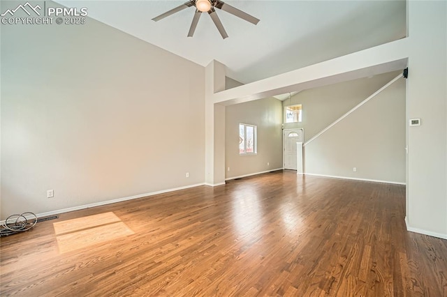 4337 Levi Ln, Colorado Springs, CO 80925 - unfurnished living room featuring baseboards, ceiling fan, wood finished floors, and high vaulted ceiling