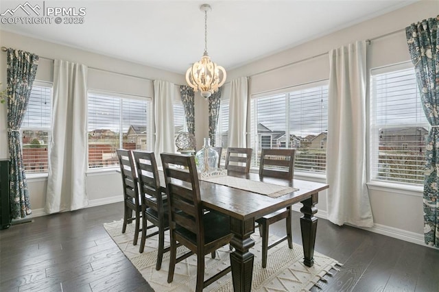 dining room featuring a healthy amount of sunlight, baseboards, and a chandelier
