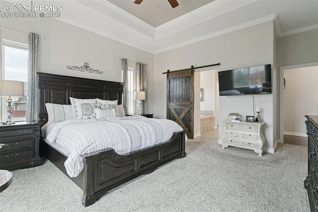 bedroom featuring ornamental molding, baseboards, a barn door, a ceiling fan, and carpet