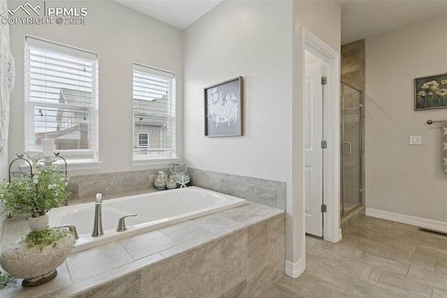 full bath featuring a shower stall, a garden tub, and visible vents