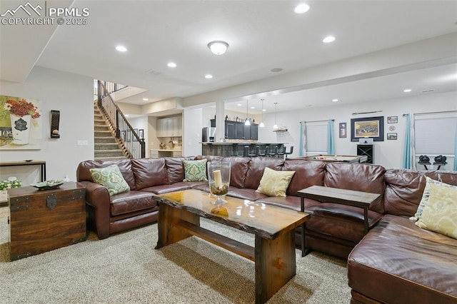 living area featuring stairway, recessed lighting, and light colored carpet