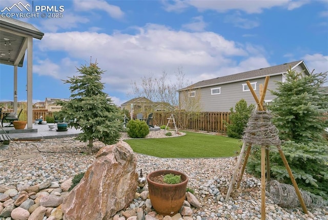 view of yard featuring fence and a patio
