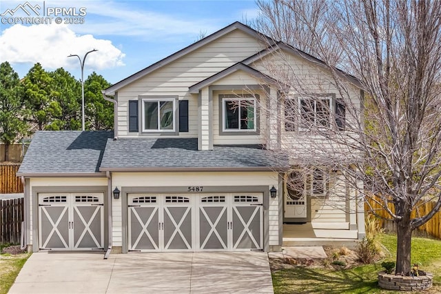 craftsman inspired home featuring concrete driveway, fence, a shingled roof, and a garage