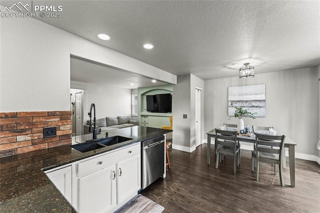 kitchen with dark wood-style flooring, a sink, dishwasher, a textured ceiling, and white cabinetry