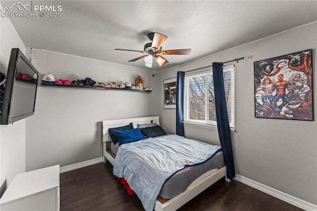 bedroom with baseboards, a textured ceiling, and wood finished floors