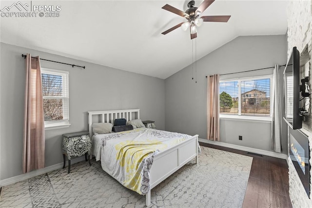 bedroom featuring baseboards, a ceiling fan, wood finished floors, and lofted ceiling