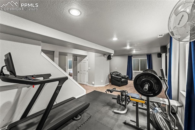 workout area with baseboards, recessed lighting, a textured ceiling, and carpet floors