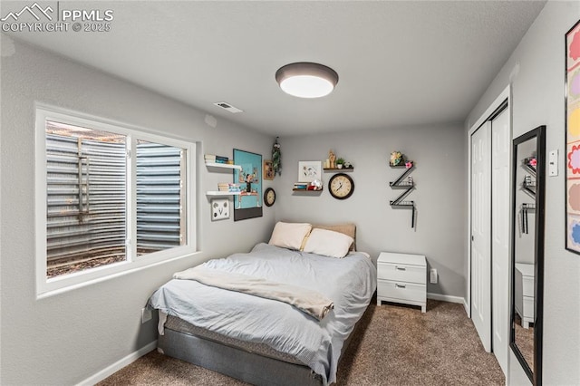 carpeted bedroom with baseboards, a closet, and visible vents