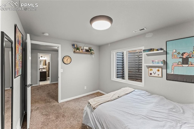 carpeted bedroom featuring baseboards and visible vents