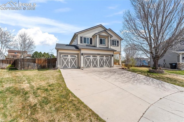 view of front of property featuring an attached garage, fence, driveway, and a front yard