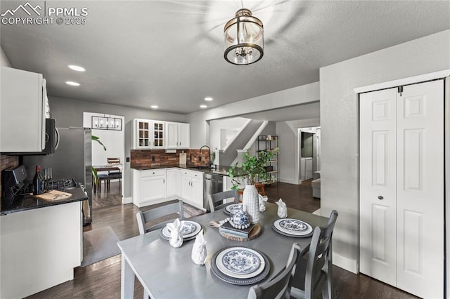 dining room featuring baseboards, recessed lighting, stairs, and dark wood-type flooring