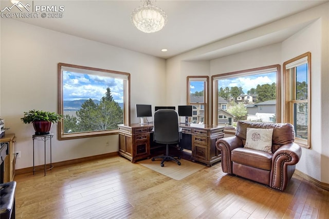 office with a chandelier, light wood finished floors, baseboards, and recessed lighting