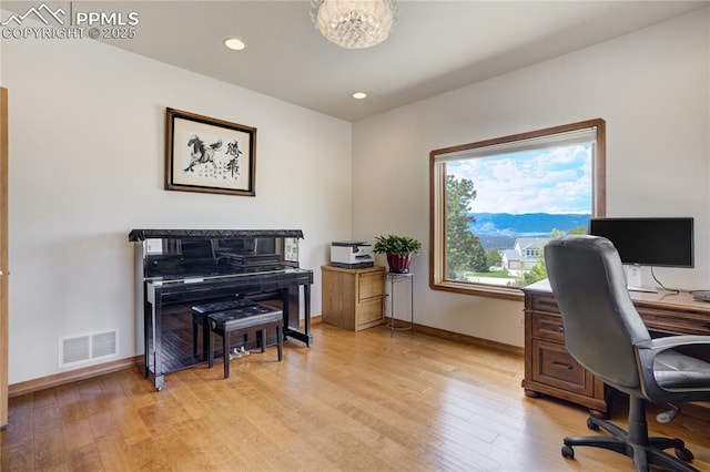 office space with baseboards, light wood-style floors, a chandelier, and recessed lighting