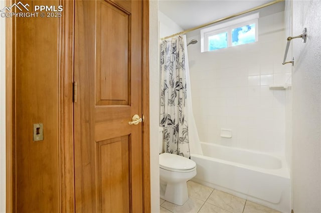 bathroom featuring tile patterned floors, toilet, and shower / tub combo with curtain
