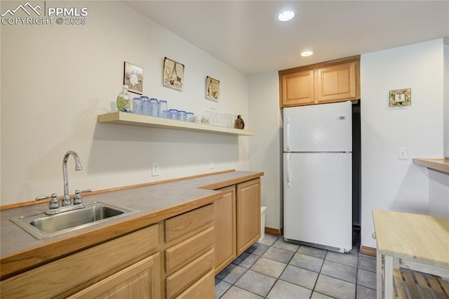 kitchen with freestanding refrigerator, a sink, open shelves, recessed lighting, and light countertops