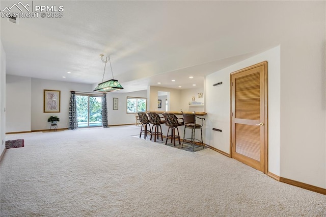 carpeted dining room with baseboards and recessed lighting