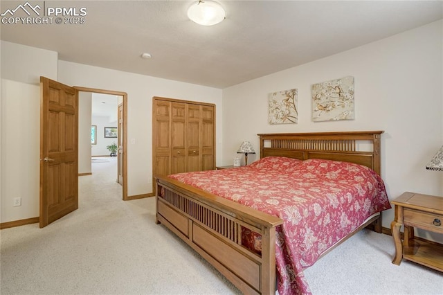 bedroom with light carpet and baseboards