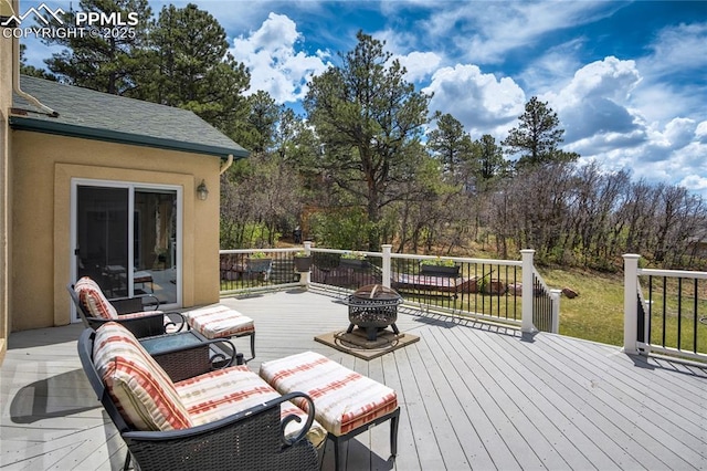 wooden deck featuring a fire pit
