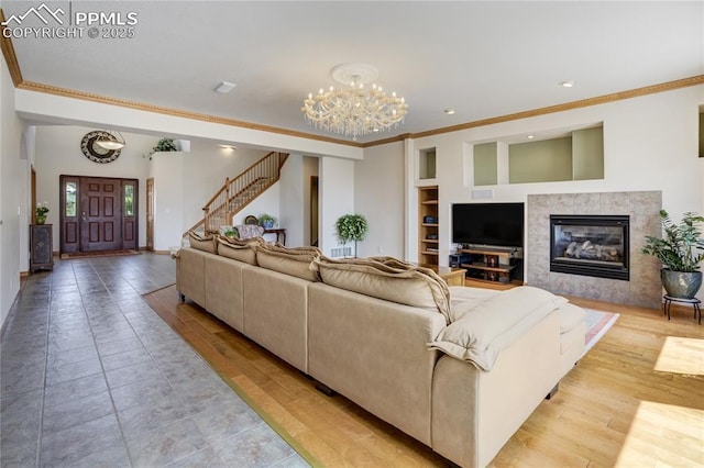 living area with crown molding, a chandelier, stairs, built in features, and recessed lighting