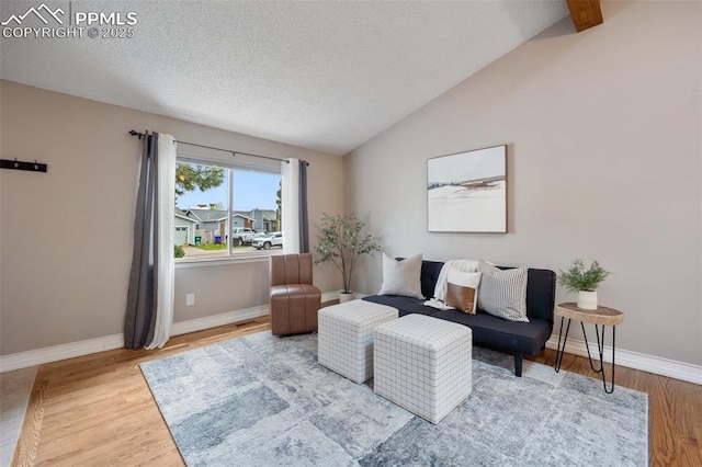 6277 Gunshot Pass Dr, Colorado Springs, CO 80917 - living area featuring lofted ceiling, wood finished floors, baseboards, and a textured ceiling