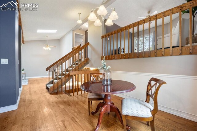 6277 Gunshot Pass Dr, Colorado Springs, CO 80917 - dining space with ceiling fan, wood finished floors, baseboards, stairway, and lofted ceiling
