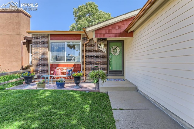 6277 Gunshot Pass Dr, Colorado Springs, CO 80917 - property entrance featuring brick siding and a yard