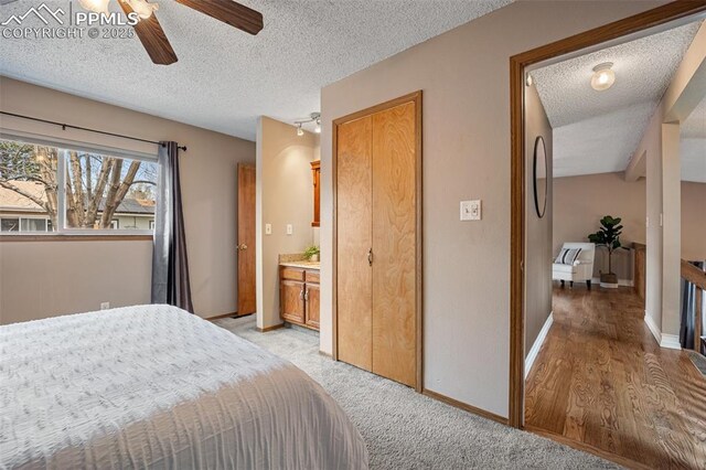6277 Gunshot Pass Dr, Colorado Springs, CO 80917 - bedroom with a textured ceiling, baseboards, a ceiling fan, and light colored carpet