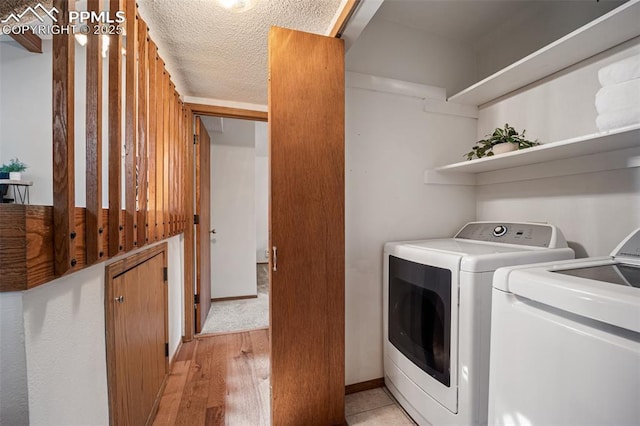 6277 Gunshot Pass Dr, Colorado Springs, CO 80917 - laundry area with washer and clothes dryer and light wood-type flooring