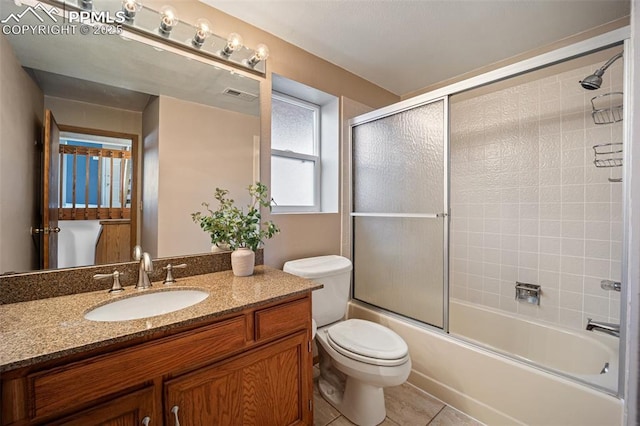6277 Gunshot Pass Dr, Colorado Springs, CO 80917 - bathroom with enclosed tub / shower combo, toilet, vanity, and tile patterned floors
