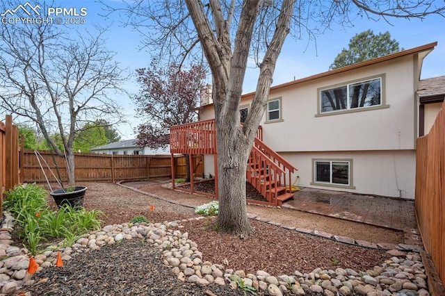6277 Gunshot Pass Dr, Colorado Springs, CO 80917 - back of house with a fenced backyard, a wooden deck, stairway, and a patio area