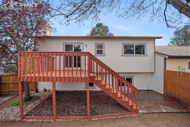 6277 Gunshot Pass Dr, Colorado Springs, CO 80917 - back of property featuring fence, a wooden deck, and stairway