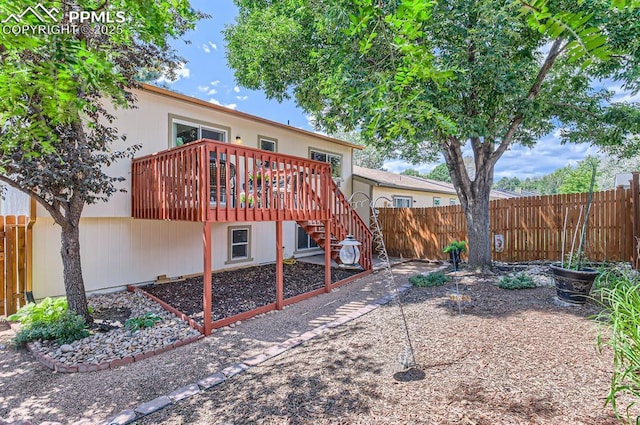6277 Gunshot Pass Dr, Colorado Springs, CO 80917 - rear view of house with fence, a wooden deck, and stairway