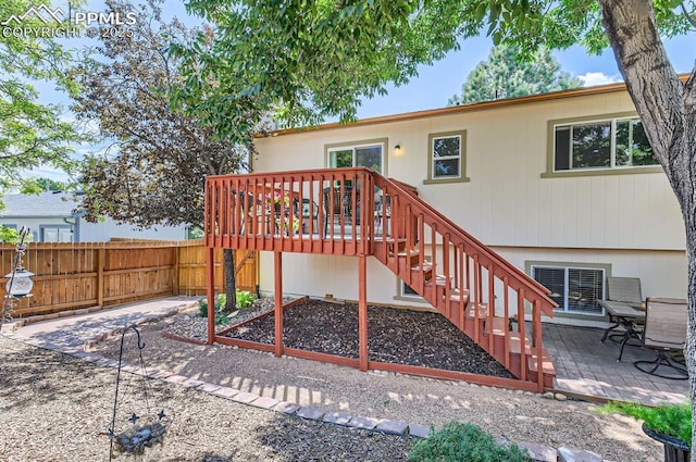 6277 Gunshot Pass Dr, Colorado Springs, CO 80917 - rear view of house featuring a patio area, fence, a deck, and stairs