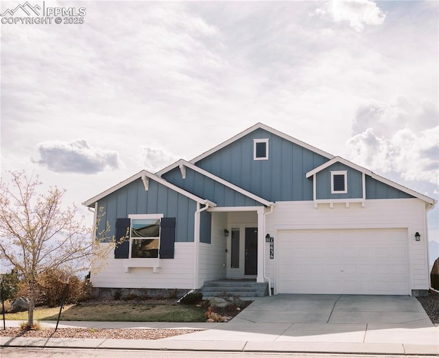 craftsman-style house featuring board and batten siding, concrete driveway, and a garage