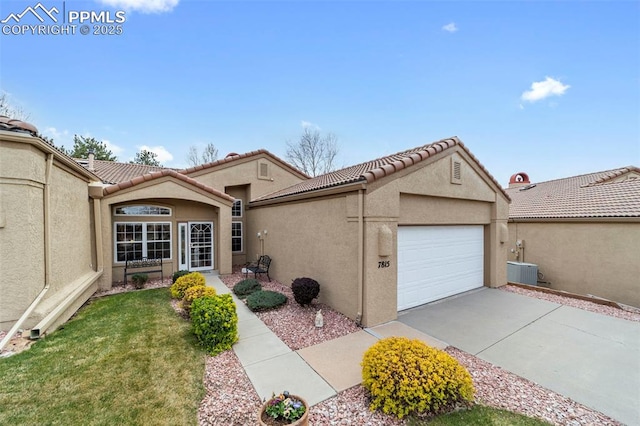 view of front of house with a garage, a tile roof, and stucco siding