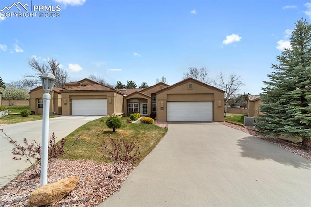 view of front of property featuring concrete driveway, a garage, and stucco siding